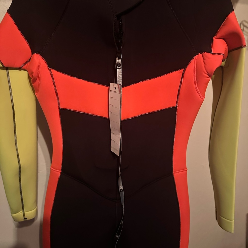 3mm full body Wet suit. Eye catching orange details. Size Large.